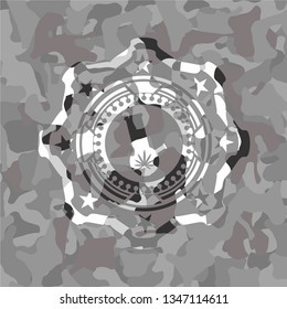 bong of marijuana icon inside grey camouflaged emblem