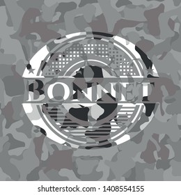 Bonnet on grey camouflaged texture