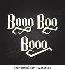 Boo halloween quote on black chalkboard background