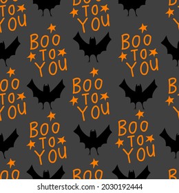 Boo to you typography design with bat hand drawn seamless pattern in doodle style on dark grey background for fashion print, wallpaper, gift wrapping paper etc.