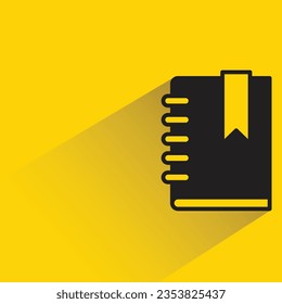 book and bookmark with shadow on yellow background