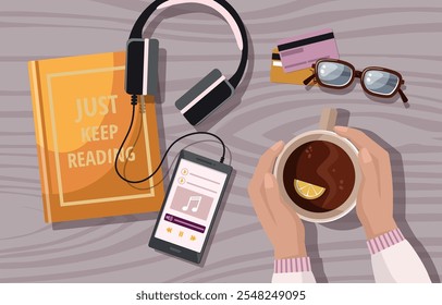 Book, coffee, mobile phone and earphones, on wooden table, flat lay.