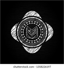book icon inside chalk emblem written on a blackboard