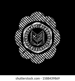 book icon inside chalk emblem written on a blackboard