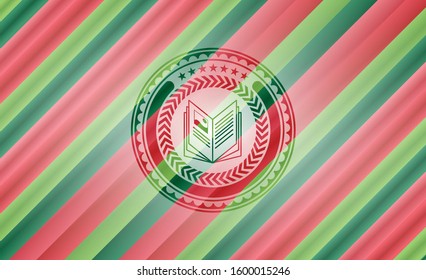 book icon inside christmas colors style emblem.