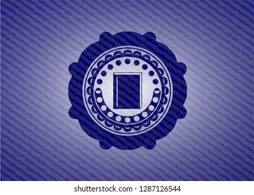 book icon inside emblem with denim texture