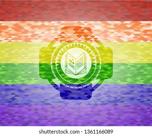 book icon inside emblem on mosaic background with the colors of the LGBT flag