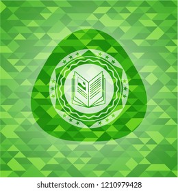 book icon inside green emblem with triangle mosaic background