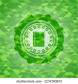 book icon inside green emblem. Mosaic background
