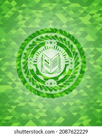 book icon inside green emblem with mosaic ecological style background. 