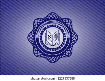 book icon inside jean or denim emblem or badge background