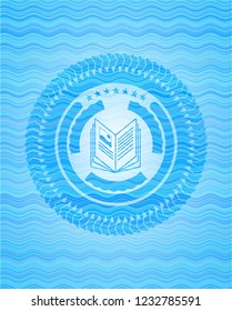 book icon inside light blue water style emblem.