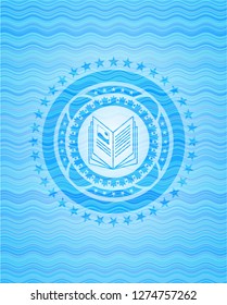 book icon inside light blue water emblem background.