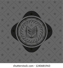 book icon inside realistic black emblem