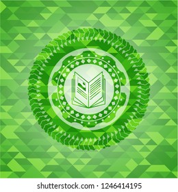 book icon inside realistic green emblem. Mosaic background
