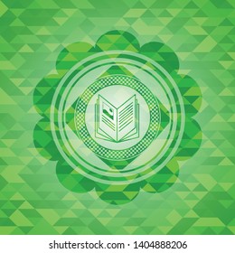book icon inside realistic green emblem. Mosaic background