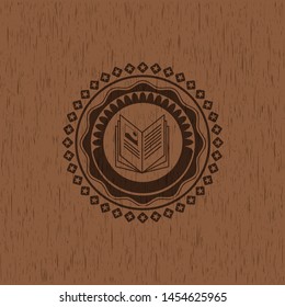 book icon inside retro style wooden emblem