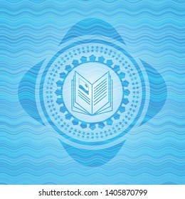 book icon inside water concept badge.