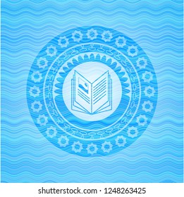 book icon inside water emblem.