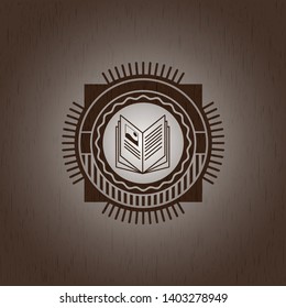 book icon inside wood badge or emblem