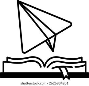 A book with a paper airplane on top of it