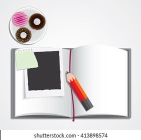 book, pencil,  donut and instant photo with pieces of paper