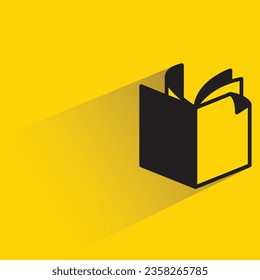 book with shadow on yellow background