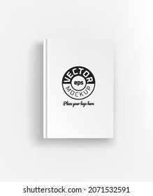 Book with white cover lying on a table. Vector mockup. Place your logo or any content