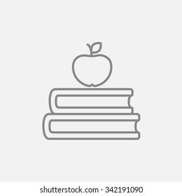 Books with apple on the top line icon for web, mobile and infographics. Vector dark grey icon isolated on light grey background.