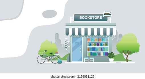 A bookstore with bicycles parked with the city in the background.
