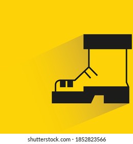 boot with shadow on yellow background
