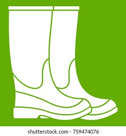 Boots icon white isolated on green background. Vector illustration