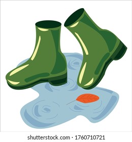 boots in a puddle with water and a leaf