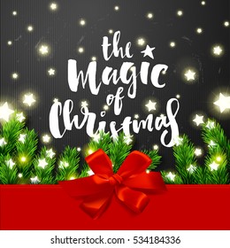 border Card design and Glowing star Lights, red bow and ribbon. poster with a handwritten inscription. Brush Calligraphy "the magic of christmas"  