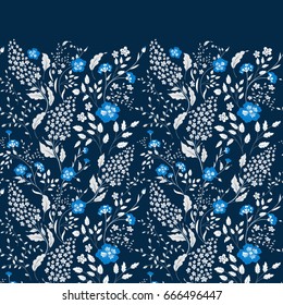 The border of delicate little blue and white flowers on navy blue background from above. Flat lay style.