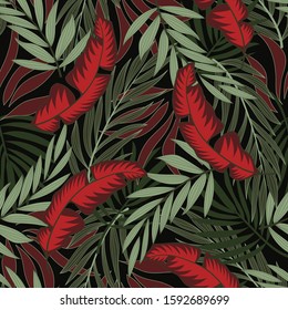Botanical seamless tropical pattern with bright red and green plants and leaves on a dark background. Summer colorful hawaiian seamless pattern with tropical plants.