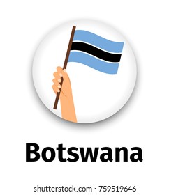 Botswana flag in hand, round icon with shadow isolated on white. Human hand holding flag, vector illustration