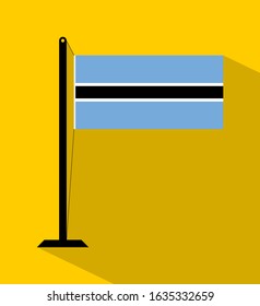 botswana flag on pole, isolated on yellow background