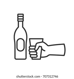 Bottle with alcohol and a glass in hand
