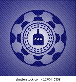 bottle of alcohol icon inside badge with denim texture