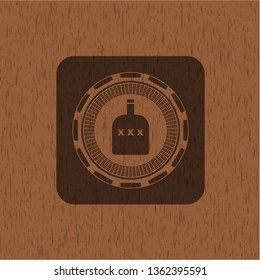 bottle of alcohol icon inside badge with wooden background