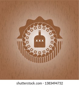 bottle of alcohol icon inside badge with wooden background