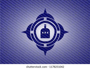 bottle of alcohol icon inside emblem with denim texture