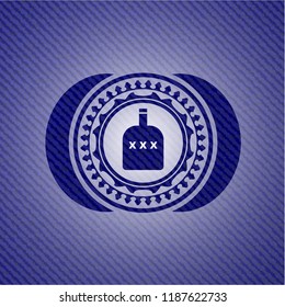 bottle of alcohol icon inside emblem with denim texture