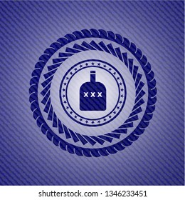 bottle of alcohol icon inside emblem with denim high quality background