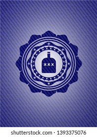 bottle of alcohol icon inside emblem with denim texture