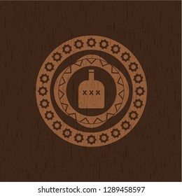 bottle of alcohol icon inside retro style wooden emblem