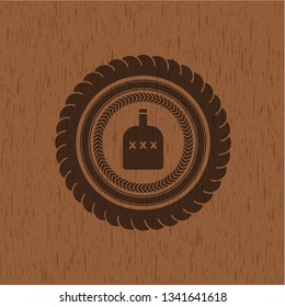 bottle of alcohol icon inside wood emblem. Vintage.