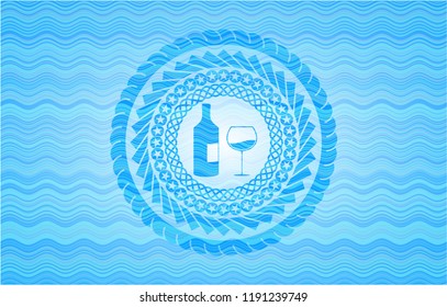 bottle and glass of wine icon inside water representation emblem.