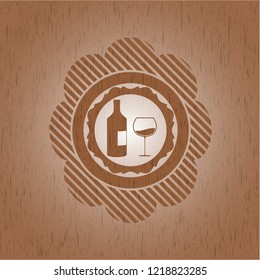 bottle and glass of wine icon inside wooden emblem. Retro